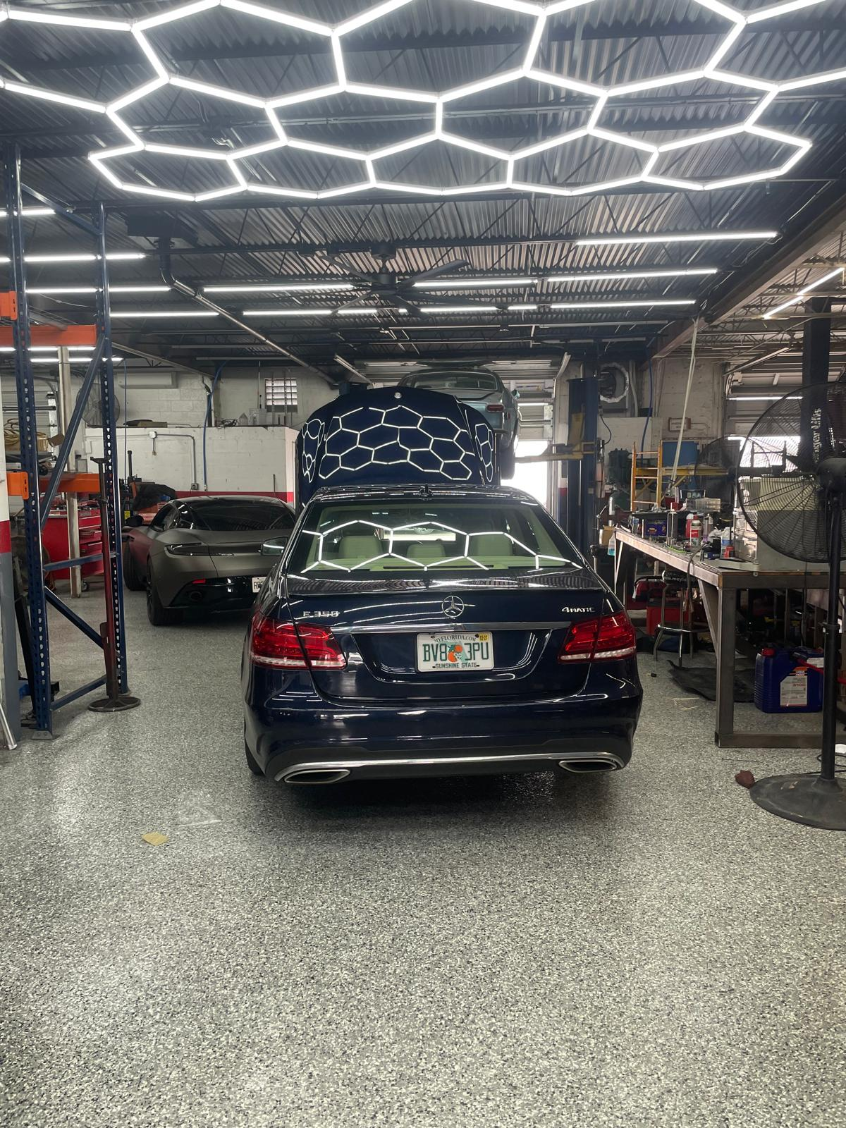 GT Motorworks epoxy floor — After — finished floor beneath showroom lighting